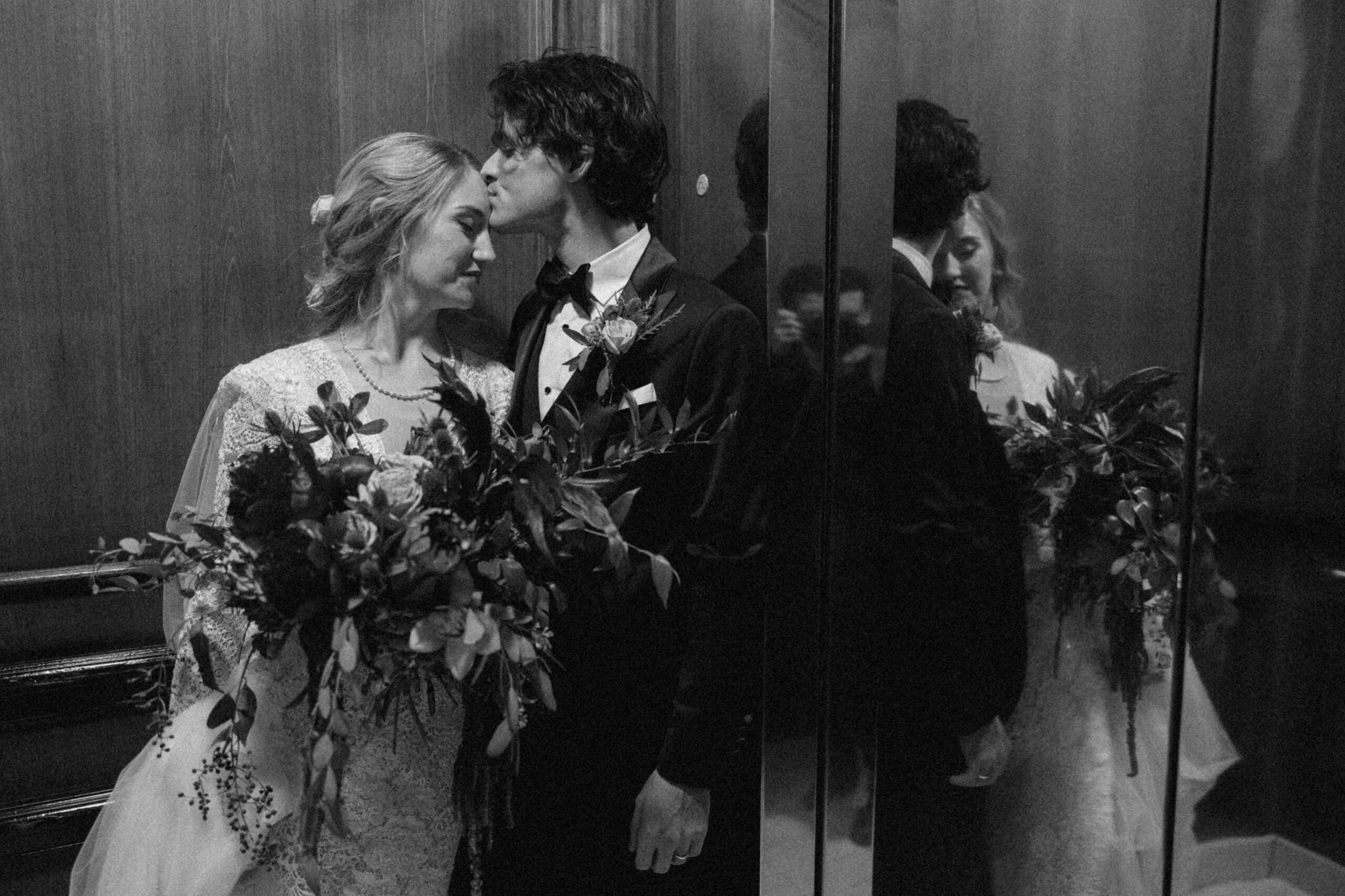 Bride and groom in elevator at Ritz Carlton in New Orleans